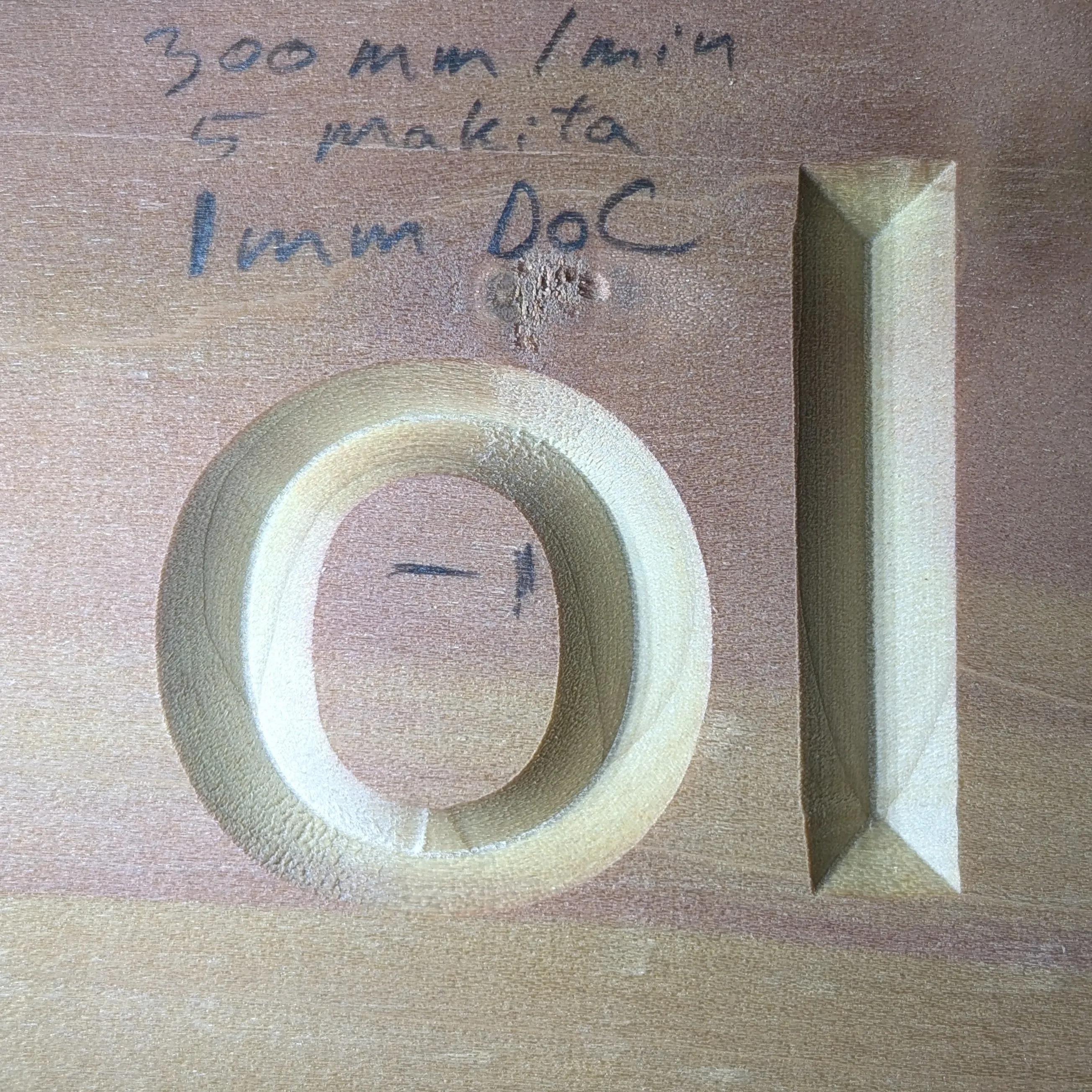 Cleanly carved test cut. Zoomed in on a sample of poplar with the letters "o" and "I" carved out.